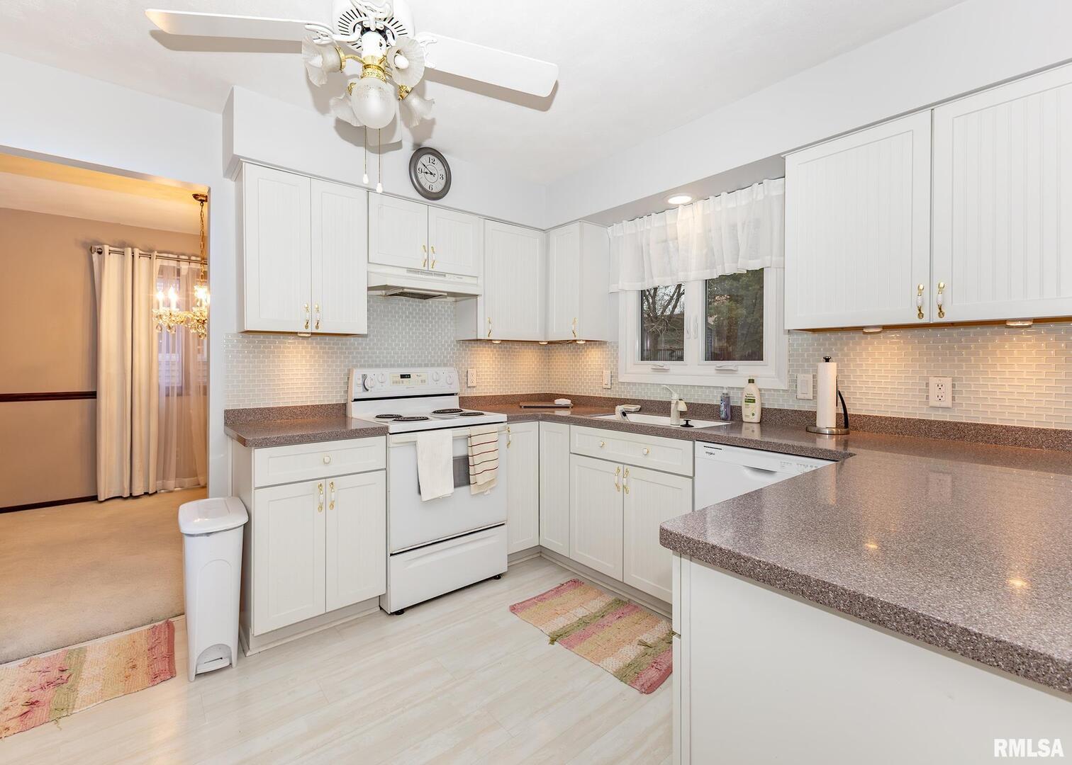 2705 36th Street Rock Island, IL 61201 - Photo 5 of 29 a kitchen with cabinets a sink and stainless steel appliances