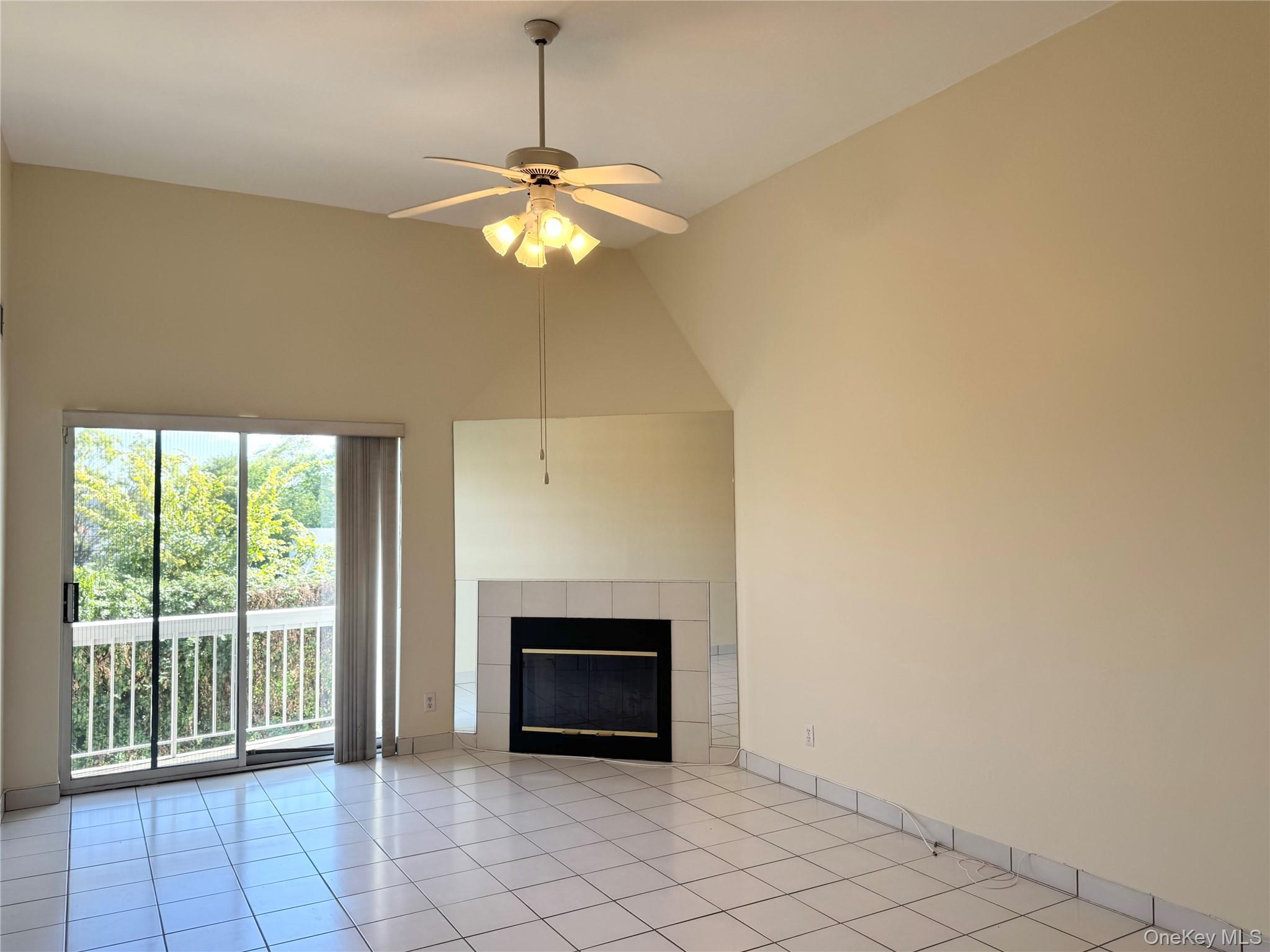 170 Schofield Street, Unit 2F Bronx, NY 10464 - Photo 3 of 11 a view of an empty room with a fireplace and a window