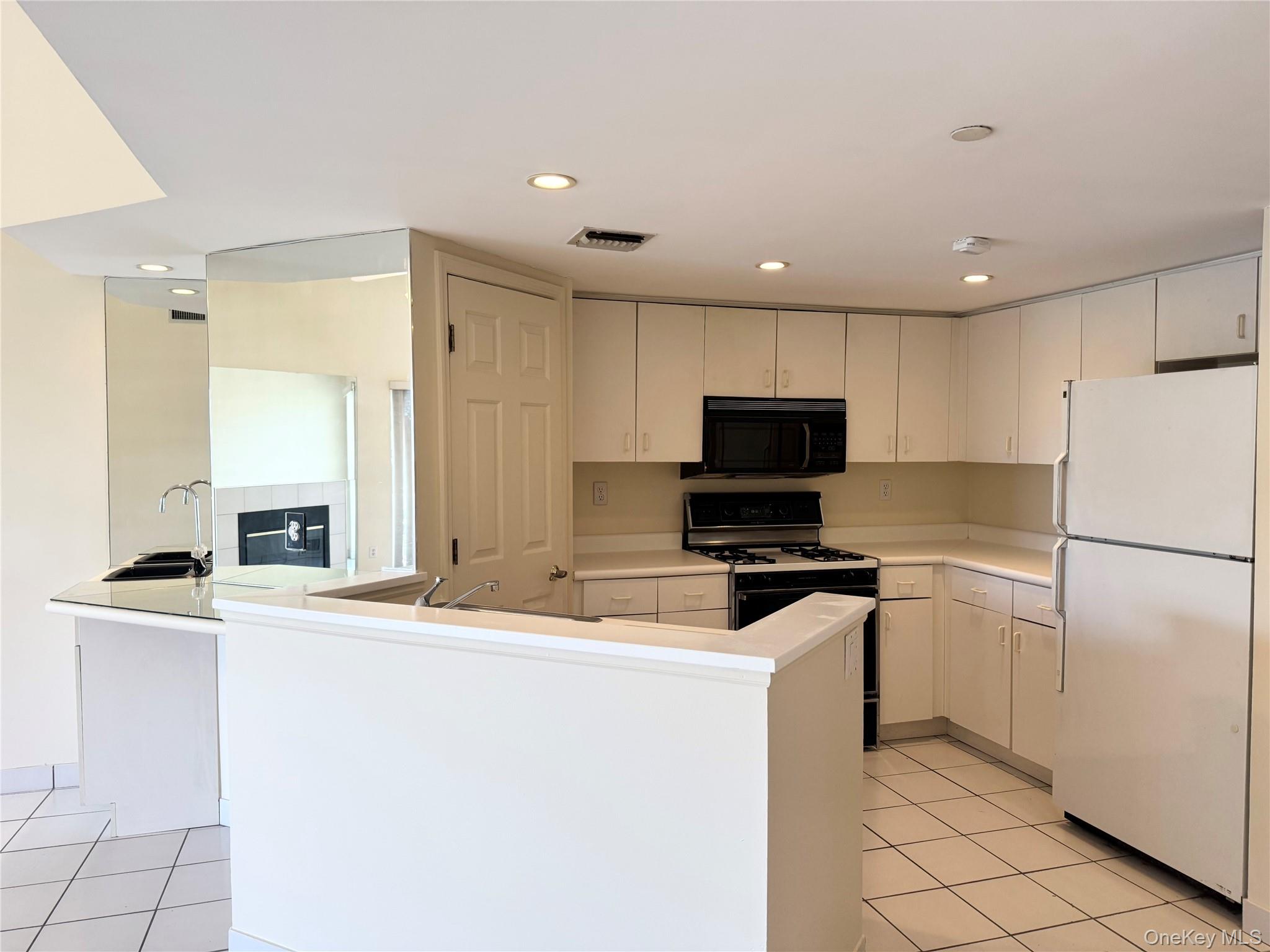 170 Schofield Street, Unit 2F Bronx, NY 10464 - Photo 5 of 11 a kitchen with granite countertop a stove a sink and a refrigerator