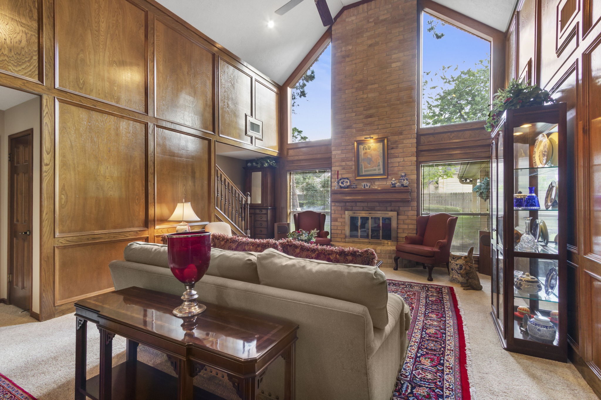 17710 Treeloch Lane Spring, TX 77379 - Photo 14 of 45 a living room with furniture a fireplace and a floor to ceiling window