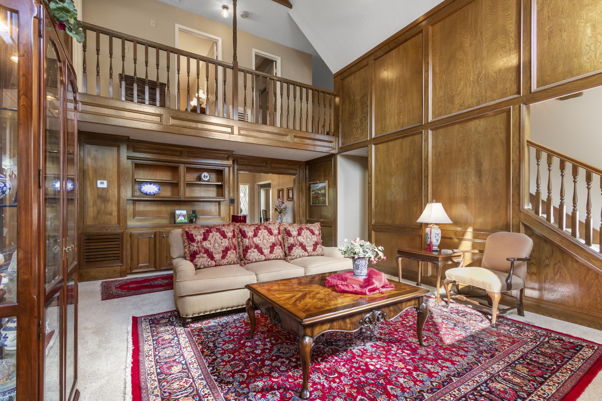 17710 Treeloch Lane Spring, TX 77379 - Photo 16 of 45 a living room with furniture a rug and a chandelier