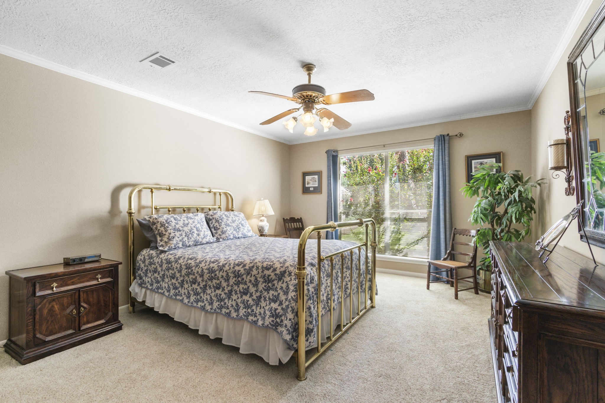 17710 Treeloch Lane Spring, TX 77379 - Photo 23 of 45 a bed room with a bed and a chandelier