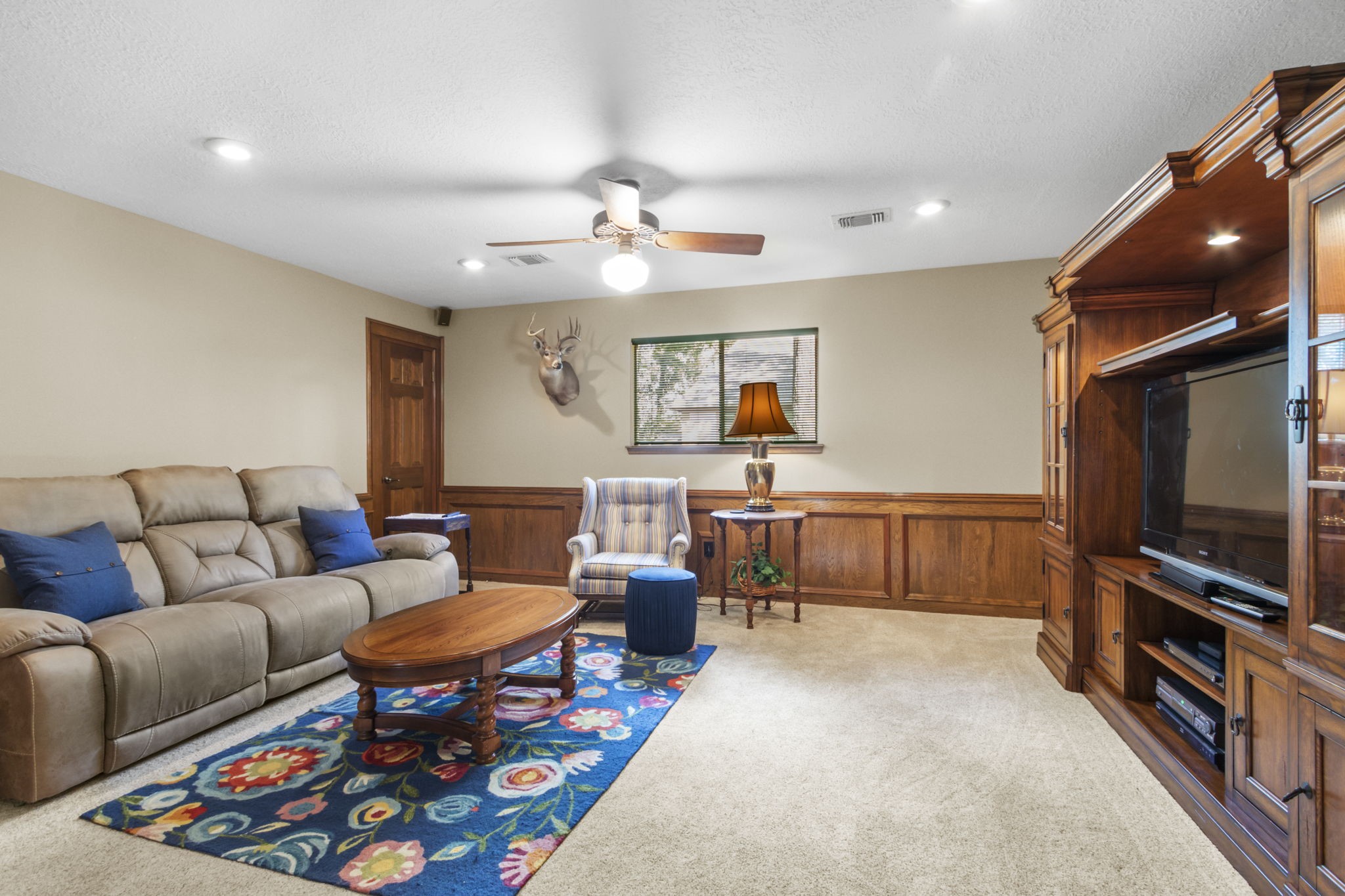 17710 Treeloch Lane Spring, TX 77379 - Photo 28 of 45 a living room with furniture and a flat screen tv