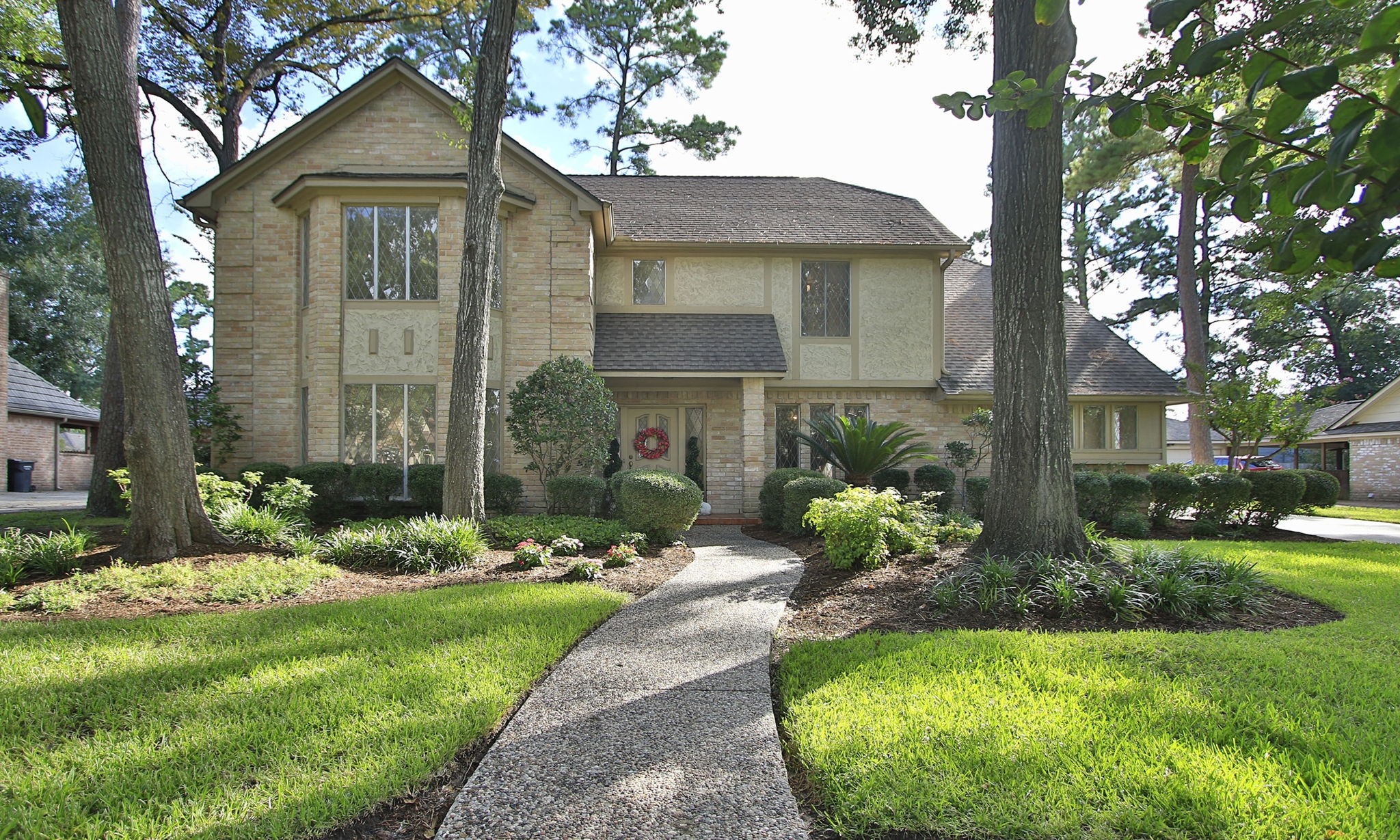 17710 Treeloch Lane Spring, TX 77379 - Photo 3 of 45 a front view of a house with a garden and plants