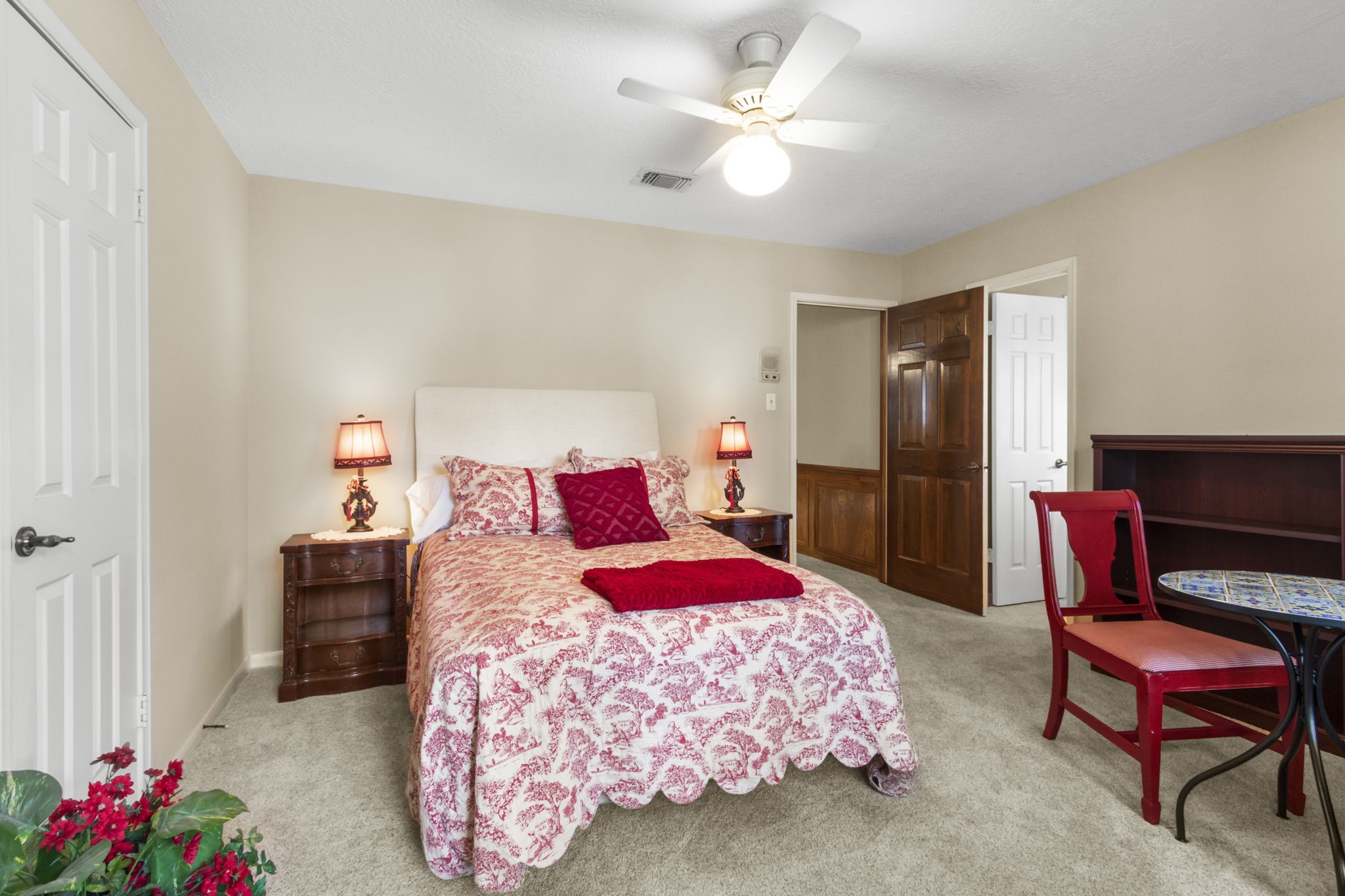 17710 Treeloch Lane Spring, TX 77379 - Photo 31 of 45 a bedroom with a bed and a chandelier