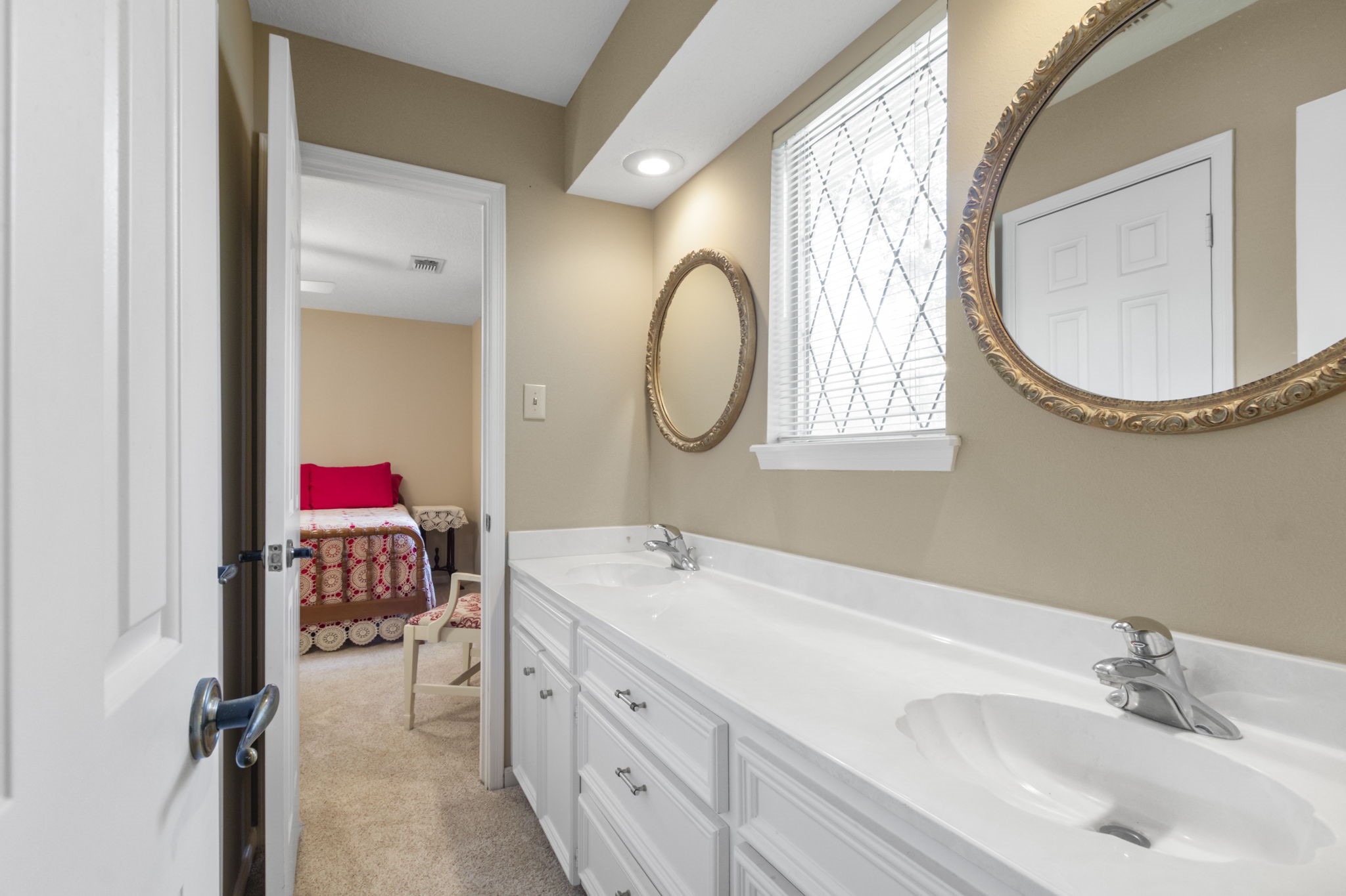 17710 Treeloch Lane Spring, TX 77379 - Photo 32 of 45 a en suite bathroom with a double vanity sink mirror and a