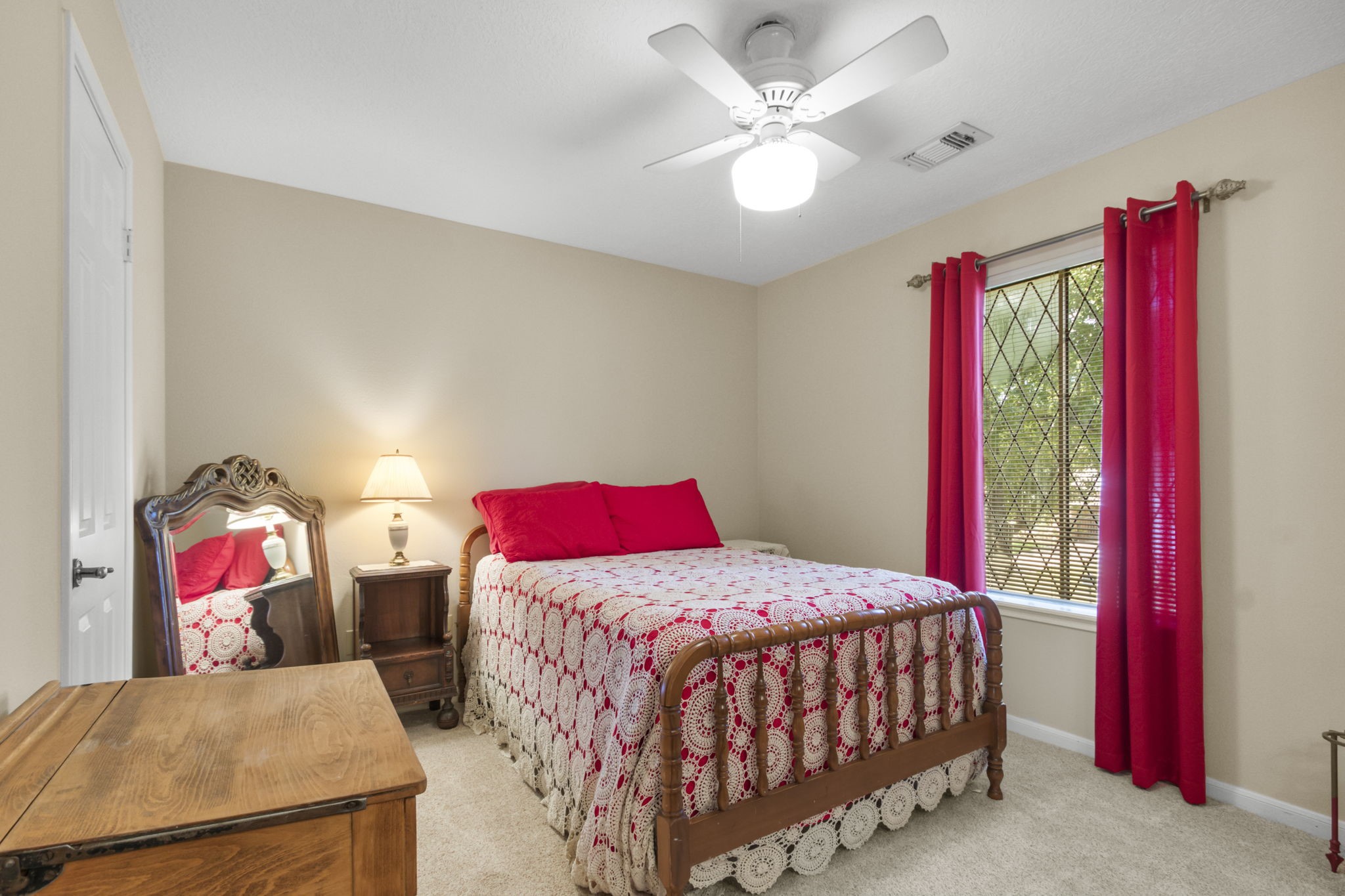 17710 Treeloch Lane Spring, TX 77379 - Photo 33 of 45 a bedroom with a bed and a chandelier