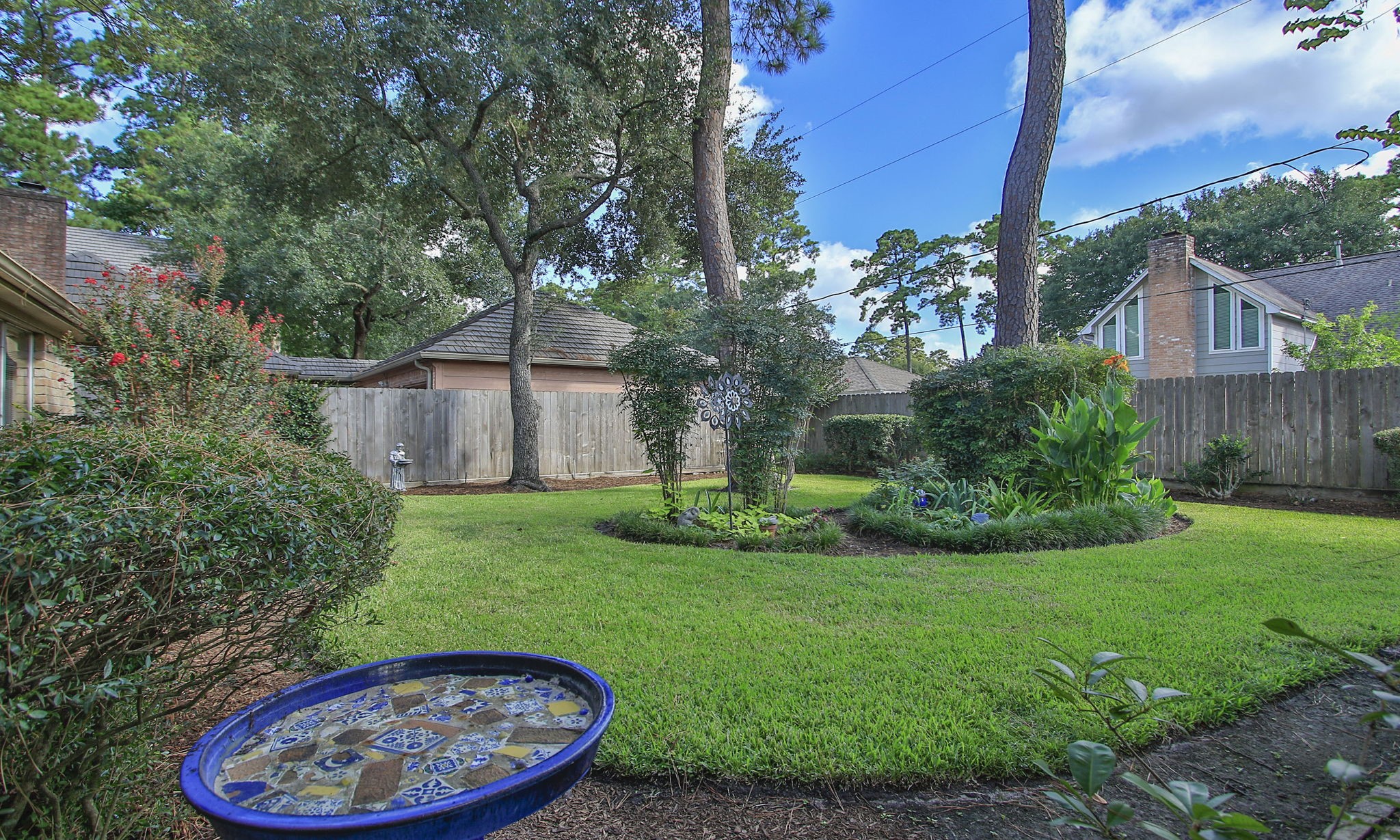 17710 Treeloch Lane Spring, TX 77379 - Photo 39 of 45 a view of a backyard with plants and a fountain