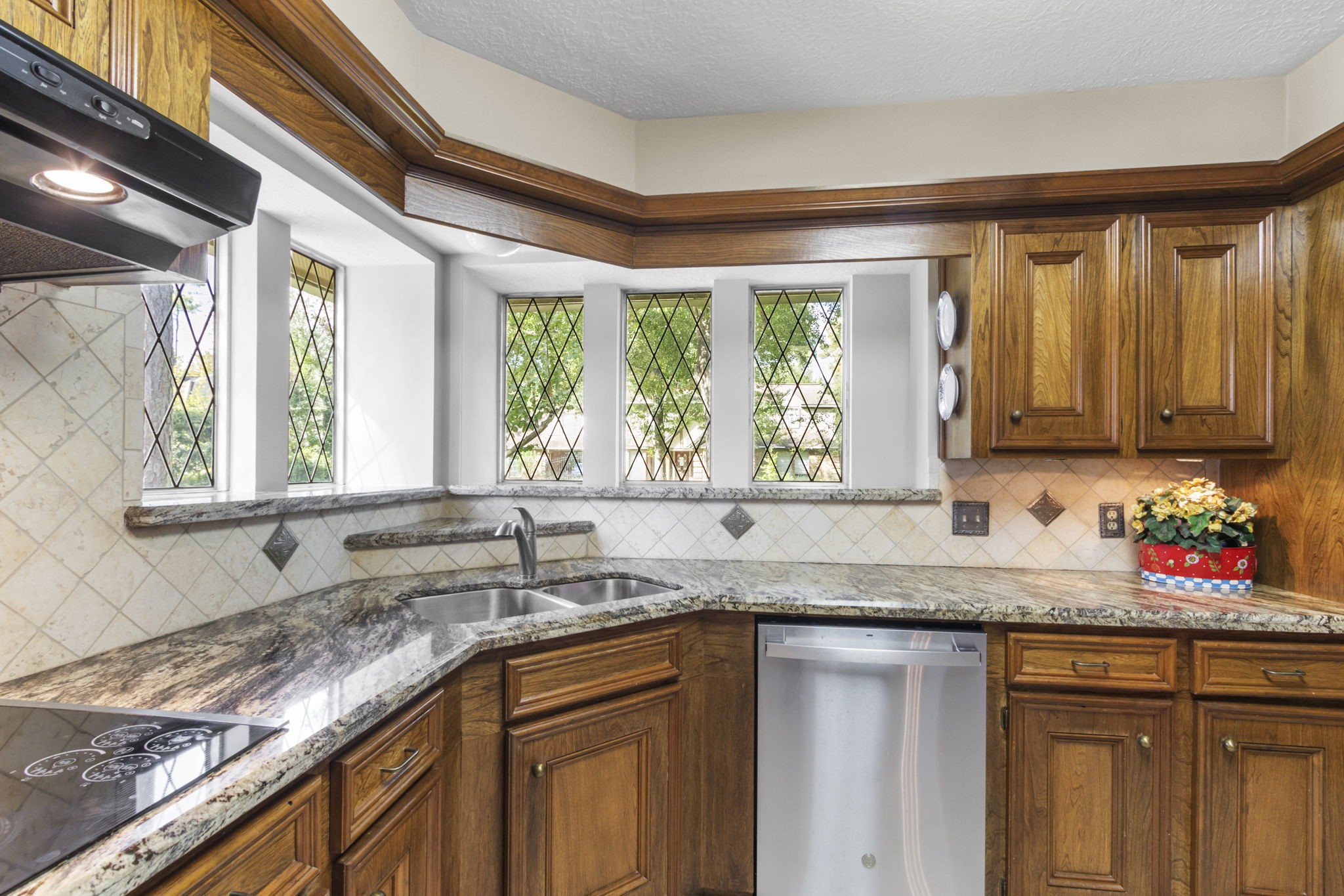 17710 Treeloch Lane Spring, TX 77379 - Photo 6 of 45 a kitchen with granite countertop a sink a window and cabinets