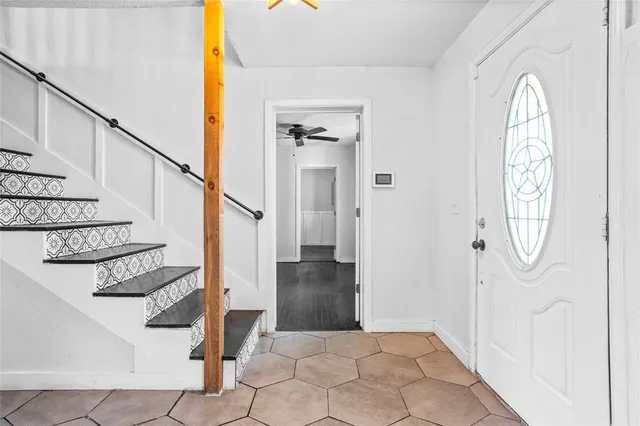 a view of entryway and hall with wooden floor