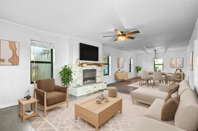 a living room with furniture a fireplace and a flat screen tv