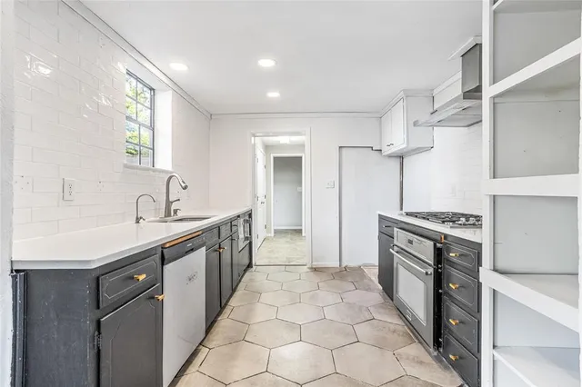 a large kitchen with cabinets and stainless steel appliances