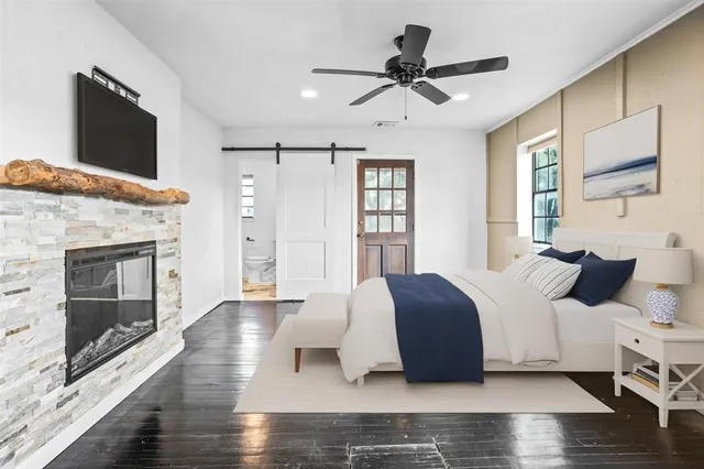 a bedroom with a bed and a fireplace