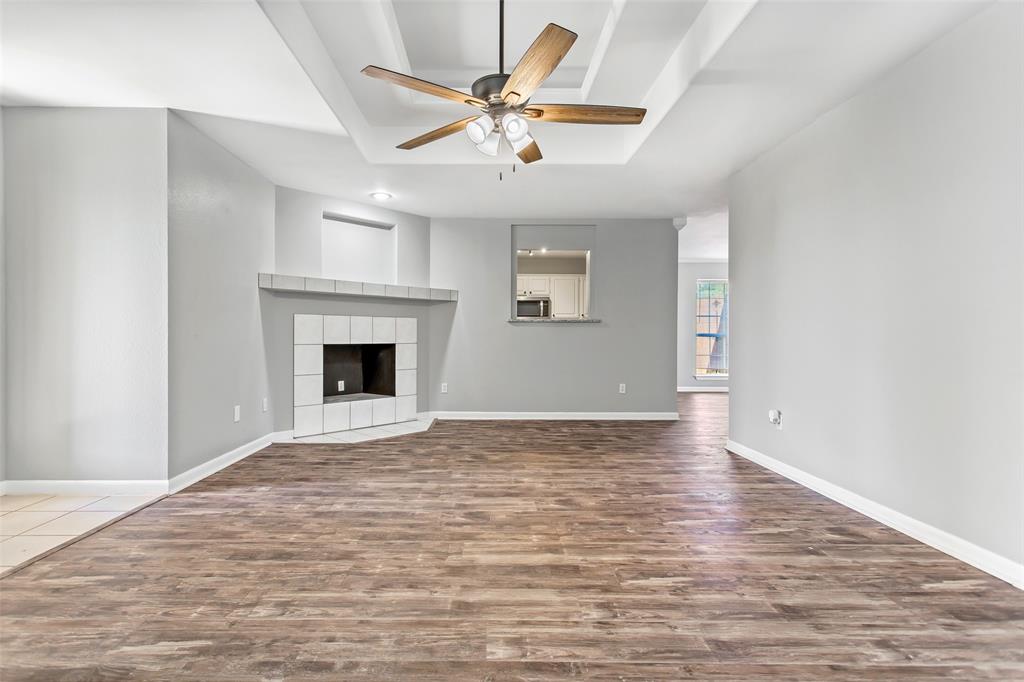 712 Billups Street Van Alstyne, TX 75495 - Photo 6 of 38 a view of an empty room with window and a fireplace