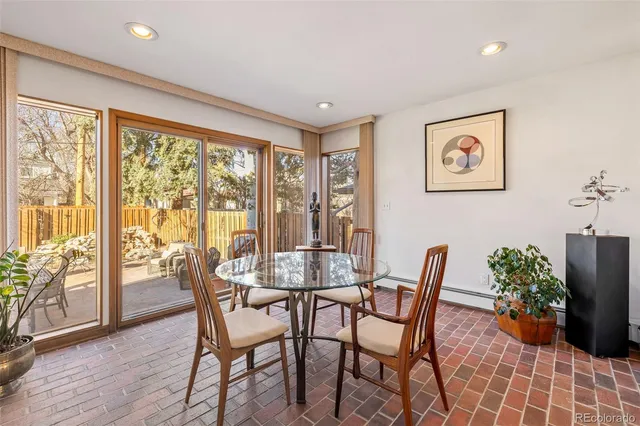 a living room with furniture a rug and a wooden floor