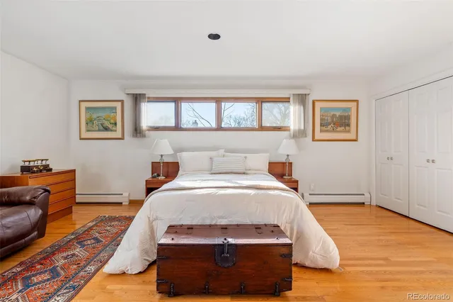 a spacious bedroom with a bed and a table in it