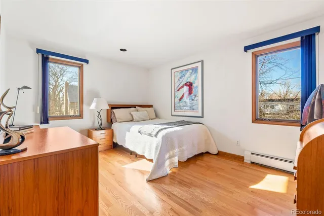 a bedroom with furniture and a flat screen tv