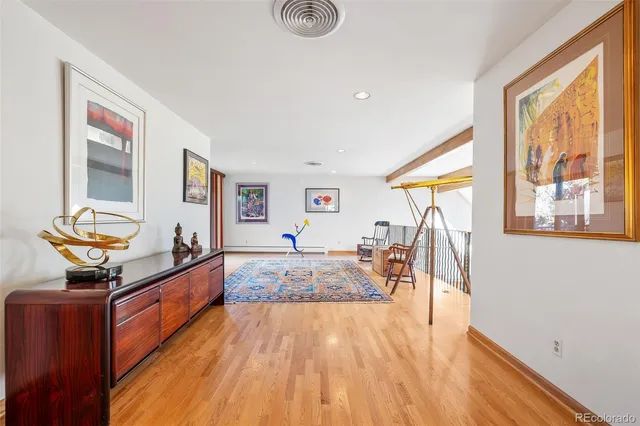 a very nice looking living room with a large window and wooden floor