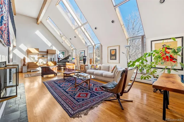 a living room with furniture a rug and a piano