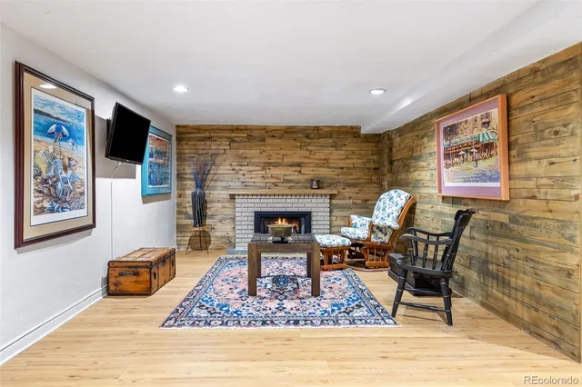 a bedroom with a bed and a lamp on dresser