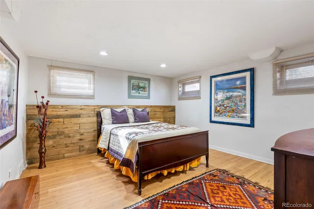 a view of a patio with couches table and chairs under an umbrella