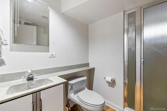 a view of a swimming pool with couches and lounge chairs