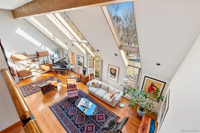 a living room with furniture a dining table and a fireplace