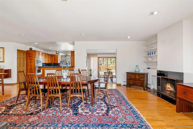 a dining room with furniture wooden floor and a rug