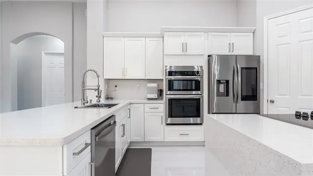 a kitchen with stainless steel appliances a refrigerator stove and sink