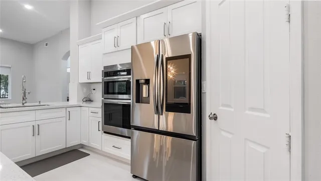 a kitchen with stainless steel appliances and refrigerator