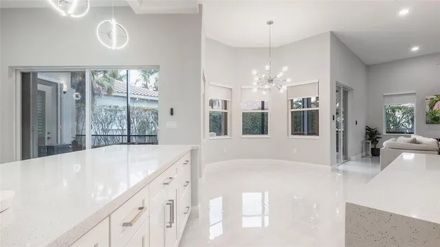 a large white kitchen with a large window