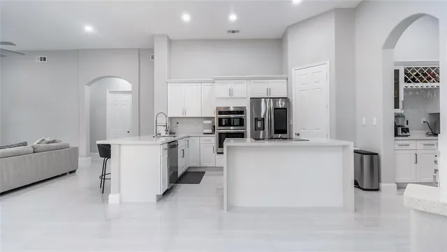 a kitchen with counter top space cabinets and stainless steel appliances