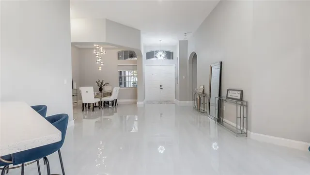 a living room with furniture a dining table and chairs