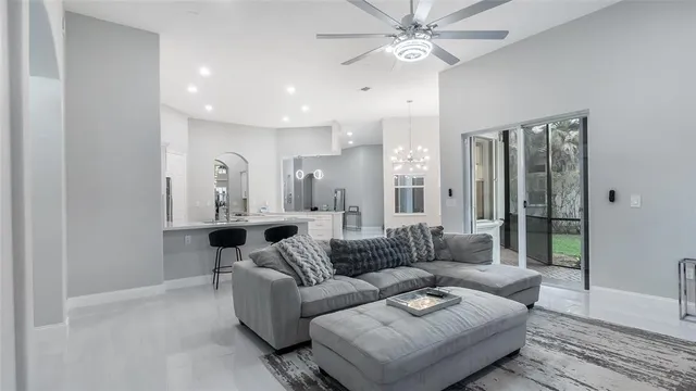 a living room with furniture and a chandelier
