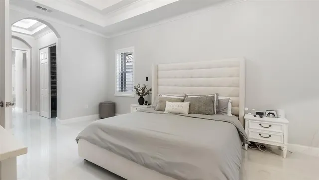 a bedroom with a bed and a night stand