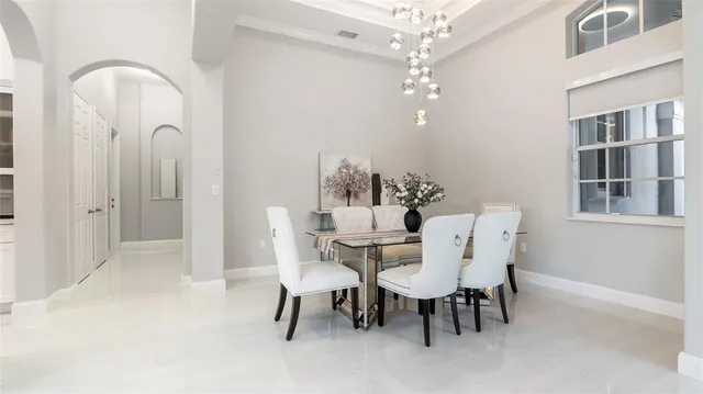 a view of a dining room with furniture and chandelier