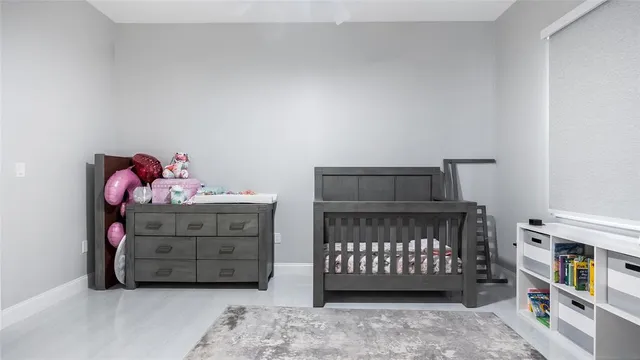 a front view of a bedroom with baby bed