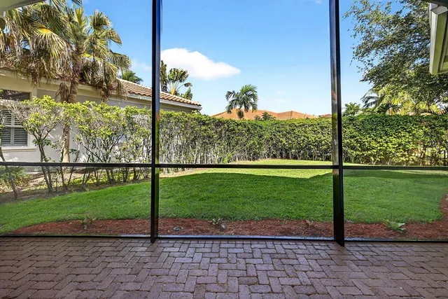 a view of a garden with a tree in the background
