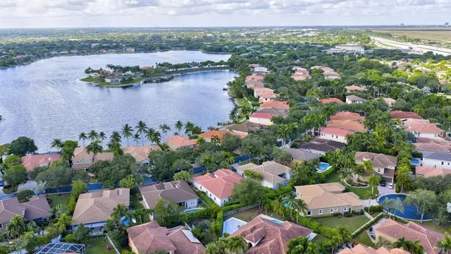 an aerial view of lake and houses with outdoor space