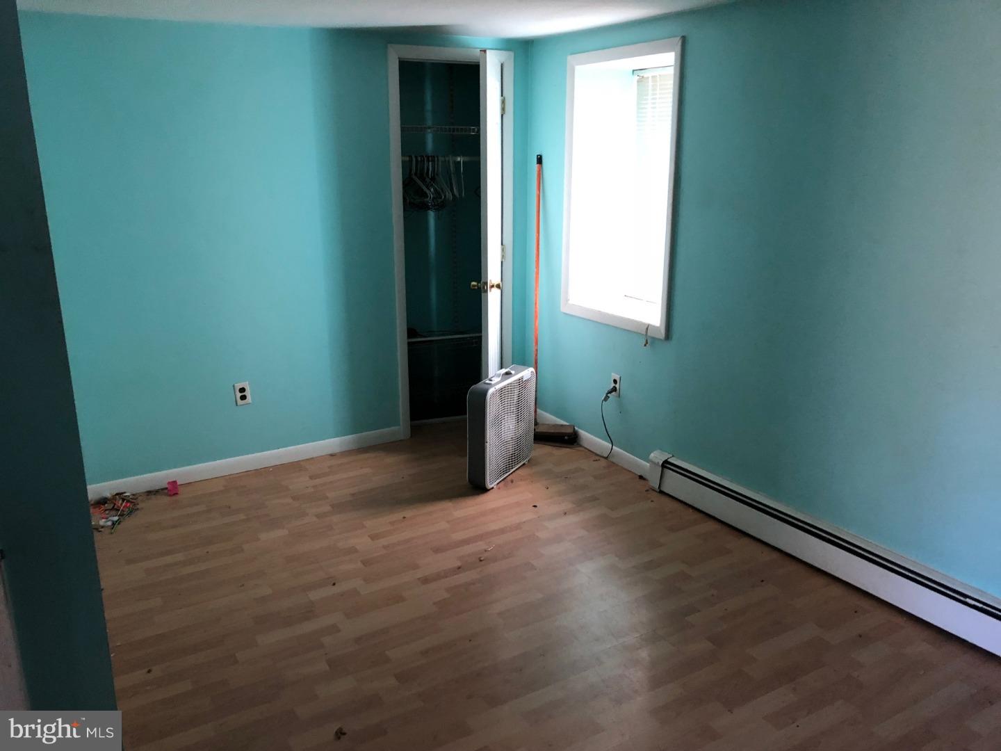 691 New Road Aston, PA 19014 - Photo 14 of 17 an empty room with wooden floor and windows