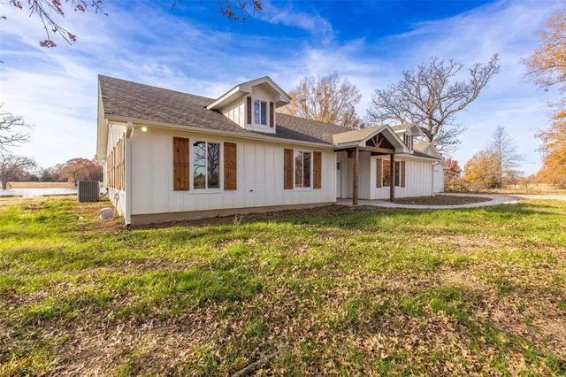 a view of an empty room with a fireplace and a large window