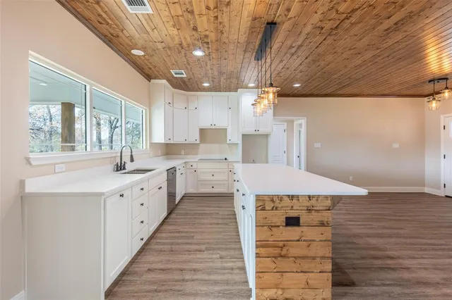 a kitchen with a sink and large window