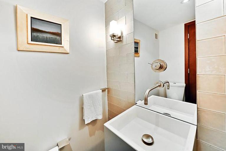 550 N Street Southwest, Unit S802 Washington, DC 20024 - Photo 11 of 30 a bathroom with a sink and a mirror