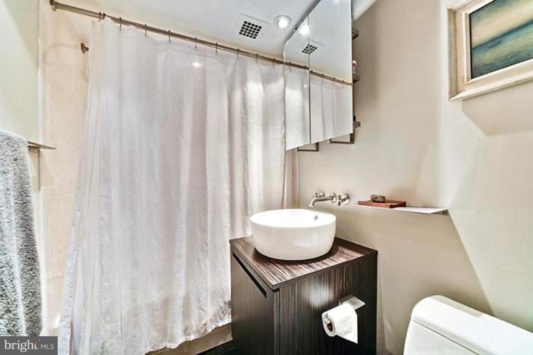 550 N Street Southwest, Unit S802 Washington, DC 20024 - Photo 14 of 30 a bathroom with a sink and a mirror