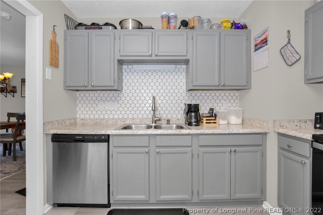 930 Rim Road Fayetteville, NC 28314 - Photo 16 of 30 a kitchen with cabinets appliances and a counter space