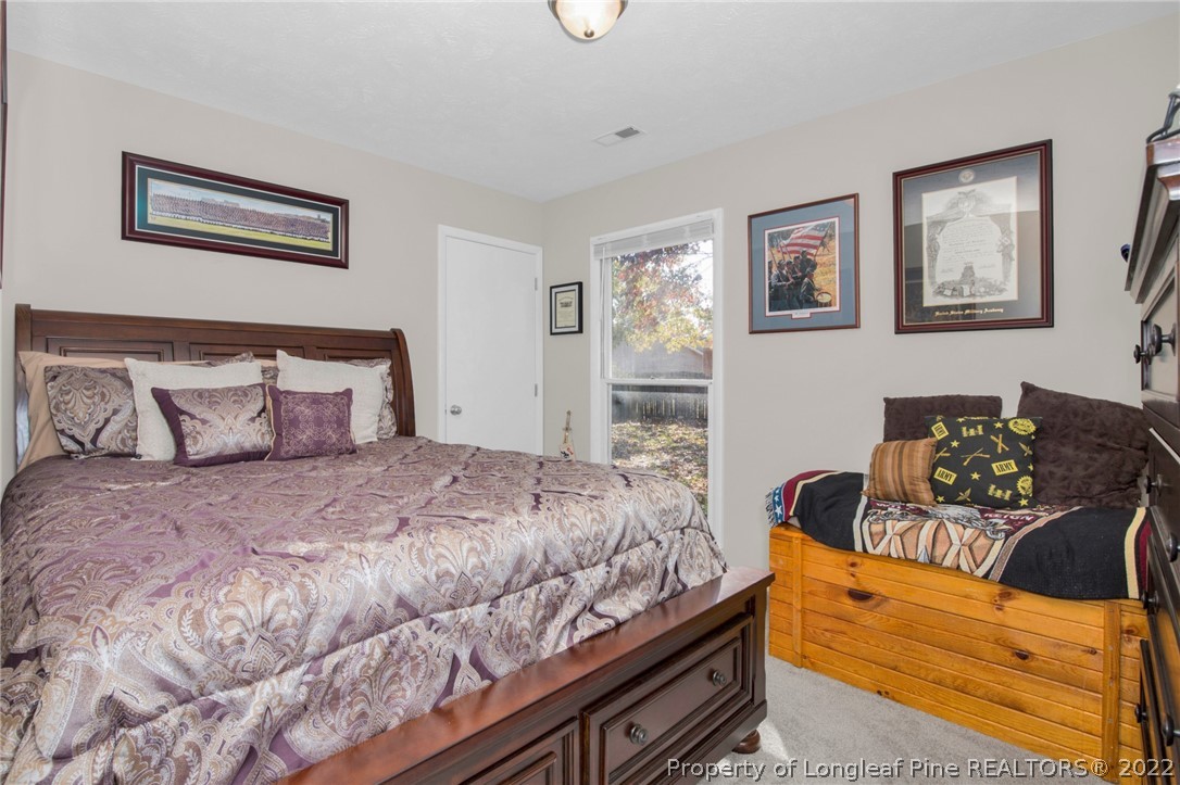 930 Rim Road Fayetteville, NC 28314 - Photo 21 of 30 a bedroom with a bed and wooden floor
