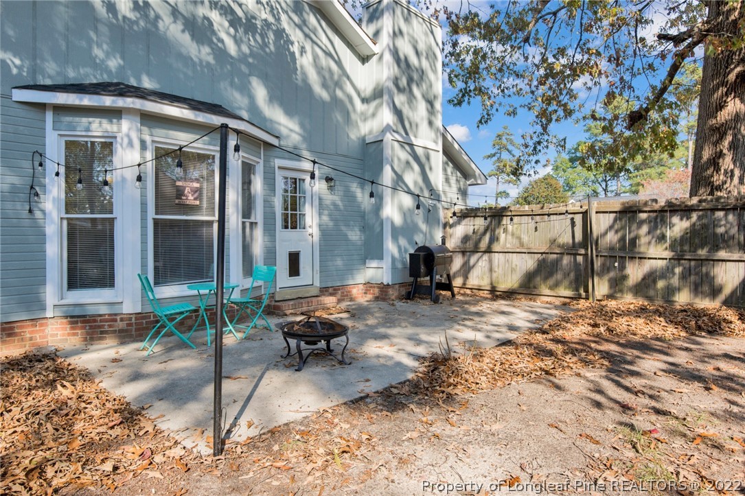 930 Rim Road Fayetteville, NC 28314 - Photo 26 of 30 a backyard of a house with barbeque oven table and chairs