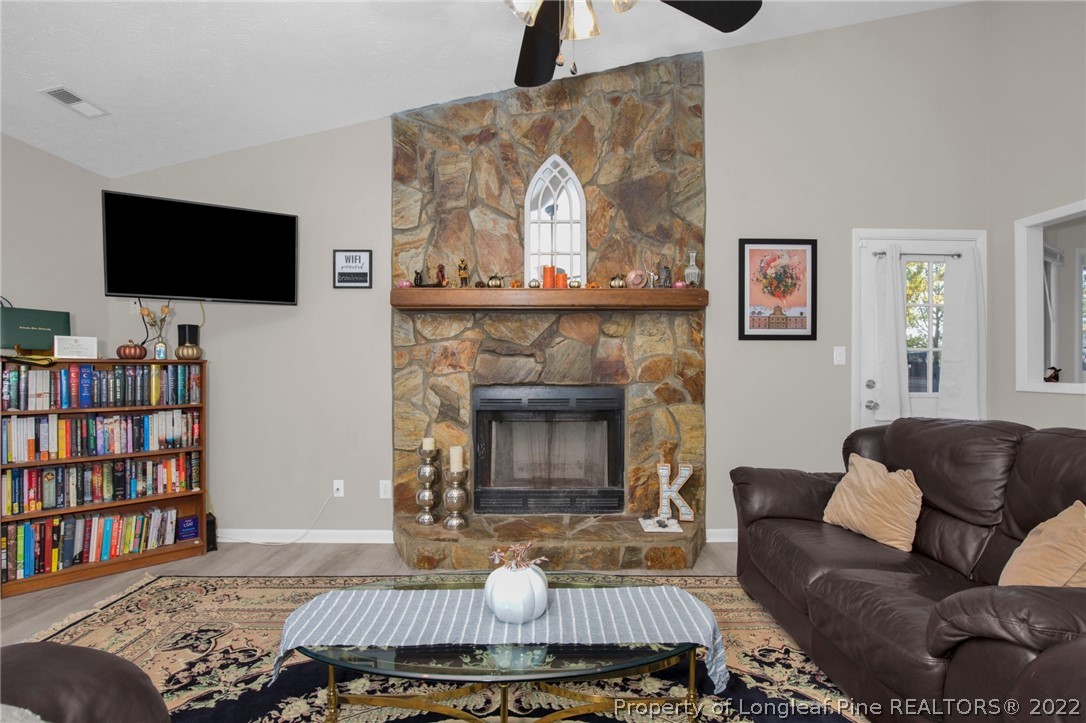 930 Rim Road Fayetteville, NC 28314 - Photo 8 of 30 a living room with furniture and a fireplace