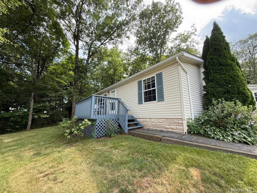 View of side of house with a deck