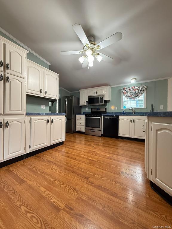 551 5th Avenue Middletown, NY 10941 - Photo 13 of 25 Kitchen featuring black appliances, white cabinetry, ceiling fan, and ornamental molding